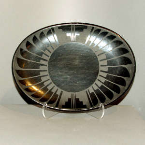 Feather and geometric design on a black on black plate