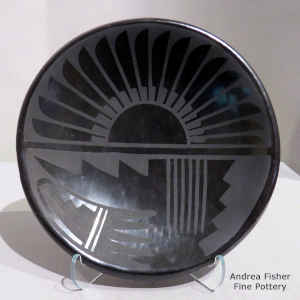 Feather and geometric design on a black on black plate