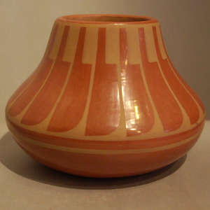 Green slip feather design on a red jar