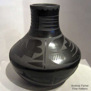 Geometric design on a tall-neck black on black jar