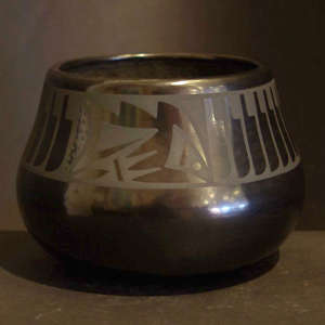 Feather and geometric design on a black on black jar