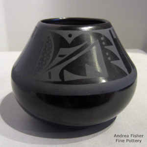 Feather and geometric design on a black on black jar