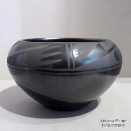 A geometric design on a black-on-black jar