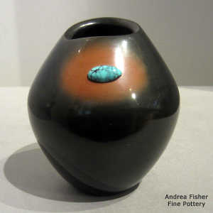 Turquoise inlay in a black and brown jar