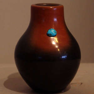 Fire cloud and inlaid turquoise on a brown jar
