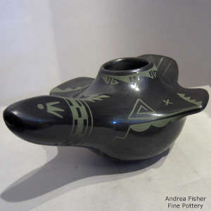 Green slip geometric design on a black bird effigy jar