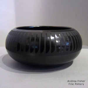 Feather and geometric design on a black on black bowl