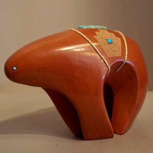Sgraffito geometric design, inlaid stones and strands of hishi beads on a red bear