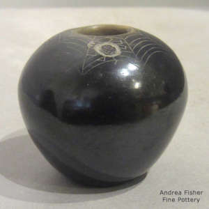 Sienna rim and sgraffito spider and web design on a miniature black jar