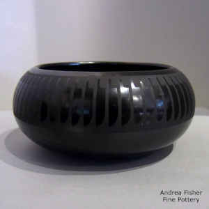 A band of feathers around a black on black bowl