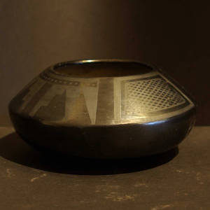 Feather and hatch design on a black on black jar