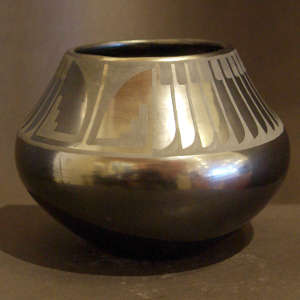 Feather and kiva step design on a black on black jar
