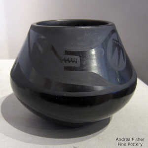 Avanyu design around a black on black jar