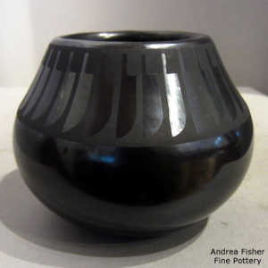 Band of feather design on a black on black jar