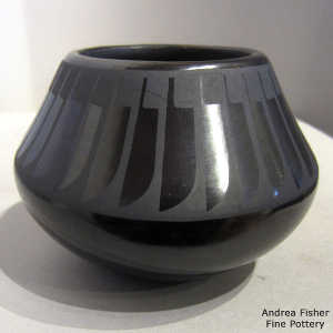 Band of feather design on a black on black jar