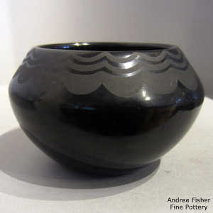 Cloud design on a black on black jar