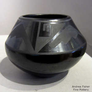 Geometric design on a black on black jar