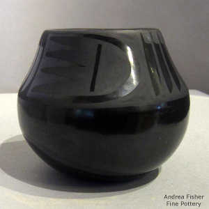 Bird element and feather design on a black on black jar