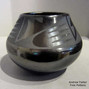 Bat wing and geometric design on a black on gunmetal black jar