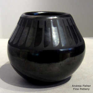 A band of feathers design on a black on gunmetal black jar