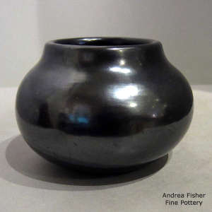 A plain, polished black jar