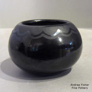 A geometric design on a black on black jar