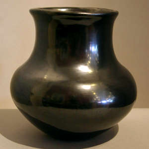 A fluted rim on a plain gunmetal black jar