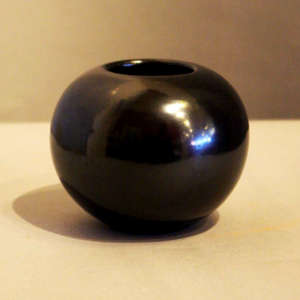 A plain, polished black jar