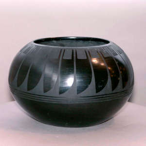 A ring of feathers design on a black on black bowl