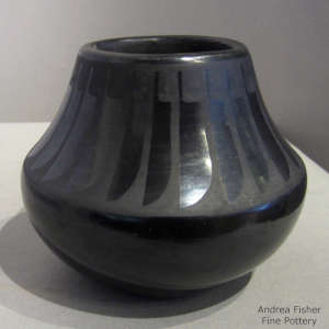 A ring of feathers design on a black on black jar