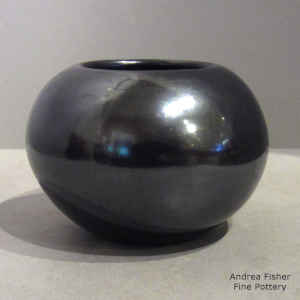 A plain, polished gunmetal black jar
