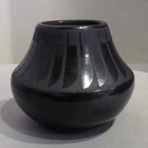 A plain, polished gunmetal black jar