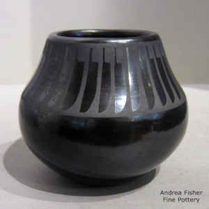 A band of feathers on a black on gunmetal black jar