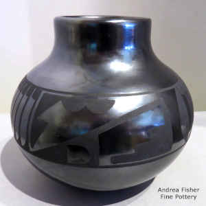 Feathers and a geometric design on a black on black jar