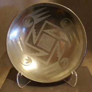 Bird wing and geometric designs on a black on black bowl