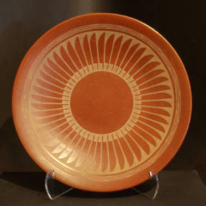 Feather design on a red plate