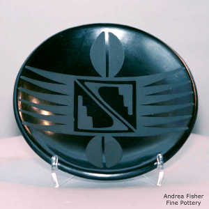 Bird wing, kiva step and deer track design on a black on black plate