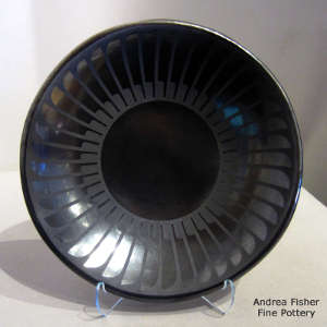 Ring of feathers design on a black on black plate