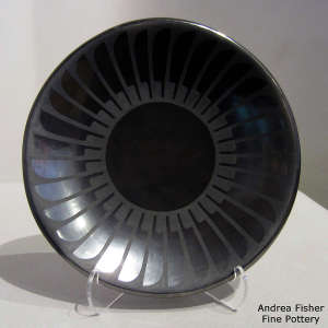 Black on gunmetal black plate with a ring of feathers design