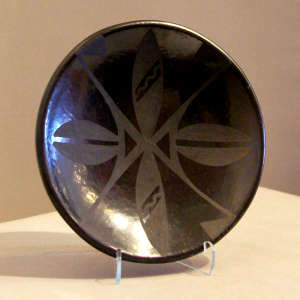 Feather design on a black on black plate