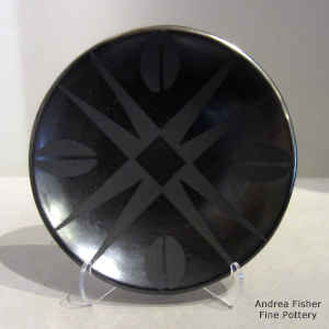 Deer hoof print and geometric design on a black on black plate