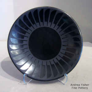 Ring of feathers design on a black on black plate