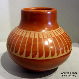 A band of feathers design around the upper shoulder of a tan on red jar