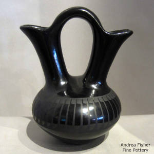 A band of feathers design on a black-on-black wedding vase