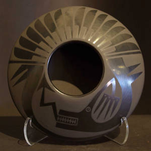 Avanyu and feather design on a black on black flying saucer jar