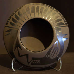 Avanyu and feather design on a black on black jar