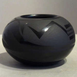 Avanyu design on a black on black jar