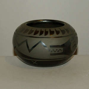 Avanyu design on a black on black jar