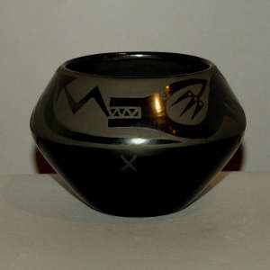 Avanyu design on a black on black jar