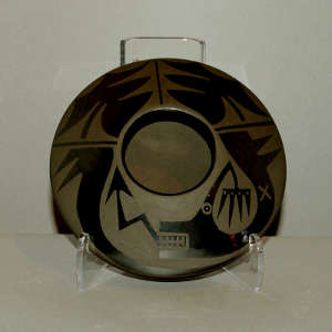 An avanyu design on a black on black jar